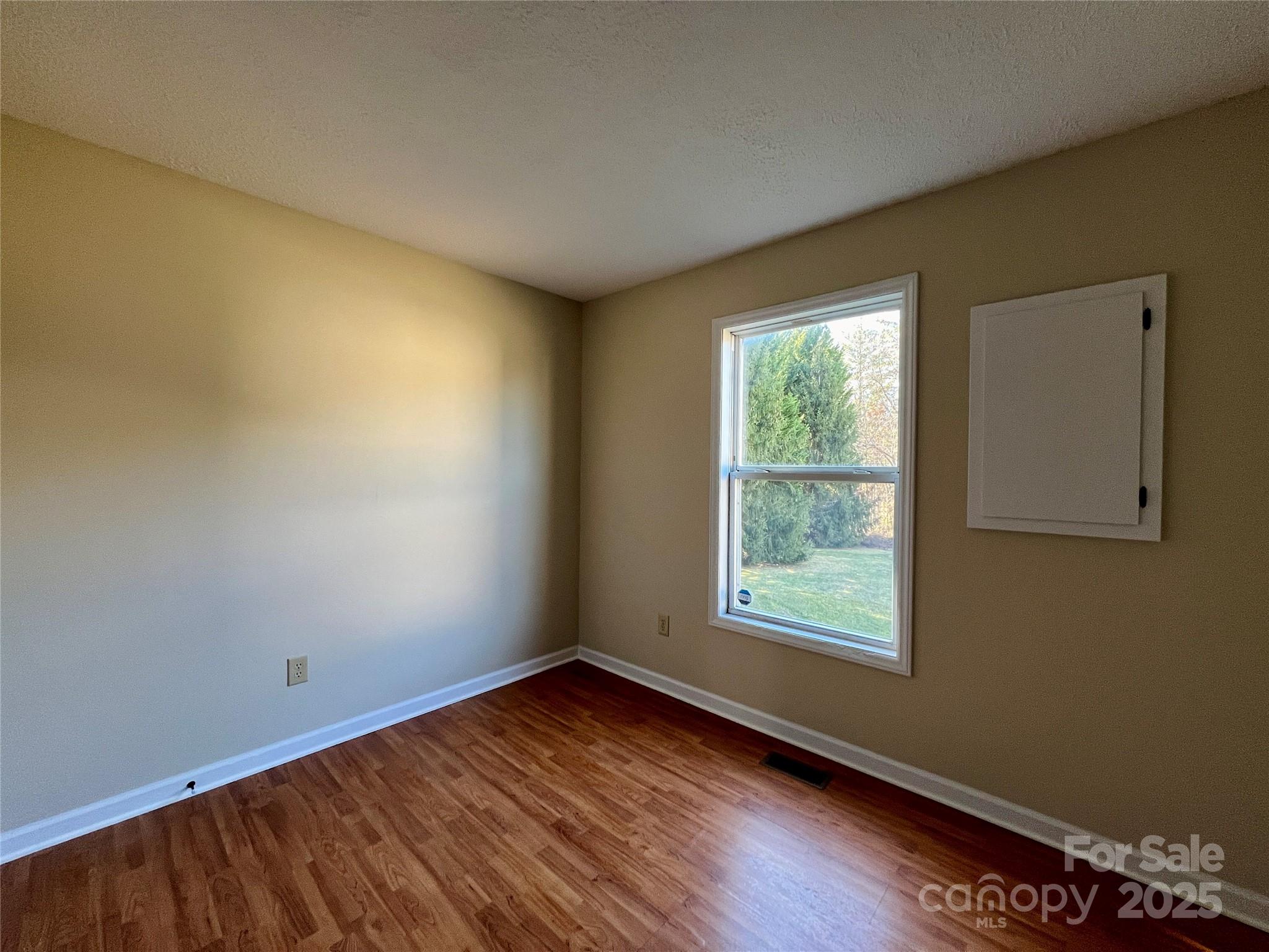 3 Wesley Branch Road Asheville, NC 28806 - Photo 14 of 19 a view of an empty room with wooden floor and a window