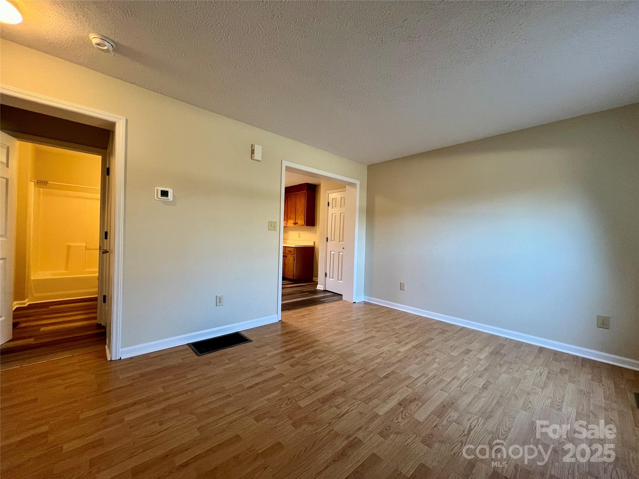 3 Wesley Branch Road Asheville, NC 28806 - Photo 4 of 19 a view of an empty room with wooden floor and a window