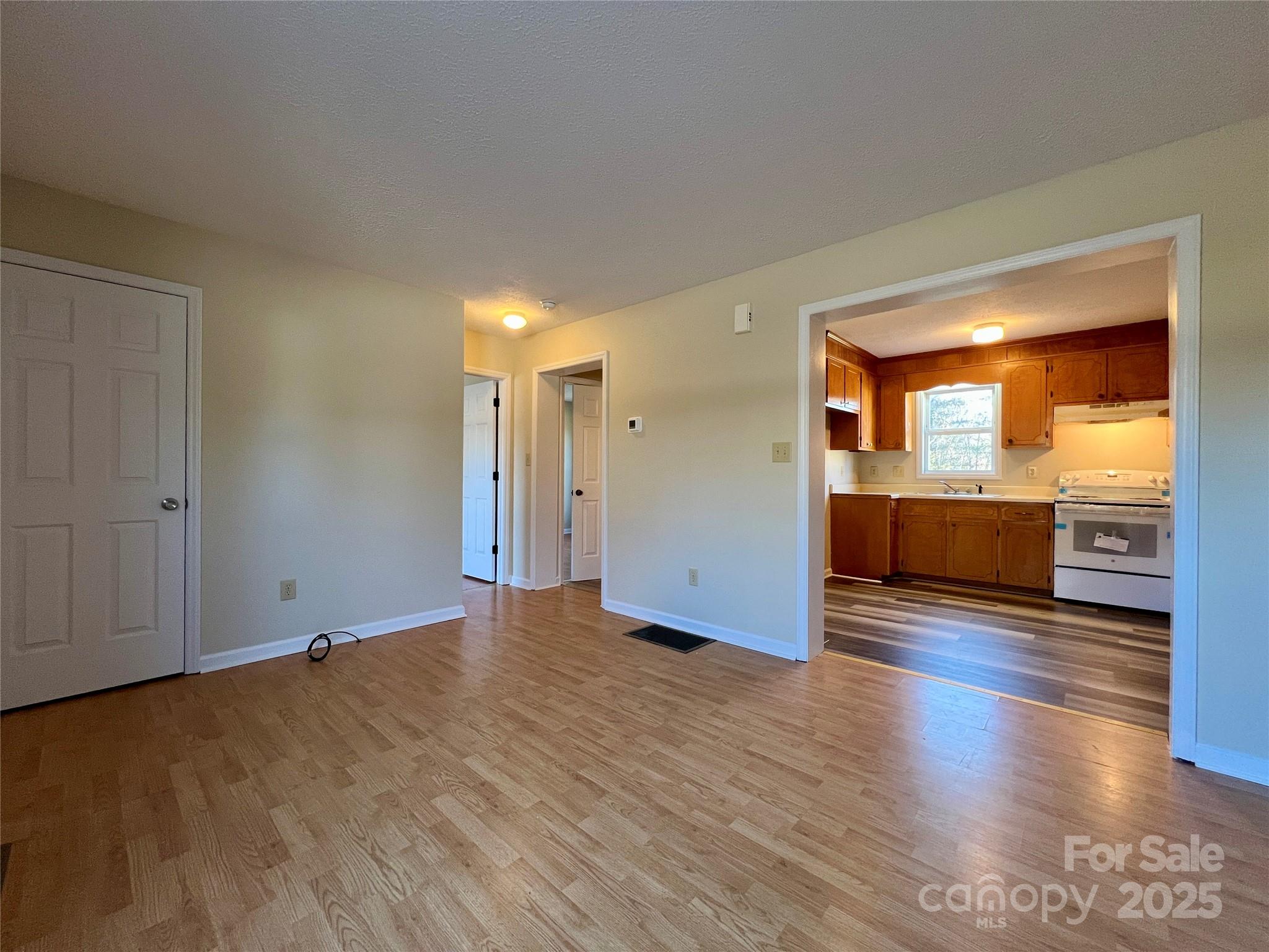 3 Wesley Branch Road Asheville, NC 28806 - Photo 5 of 19 an empty room with wooden floor and windows