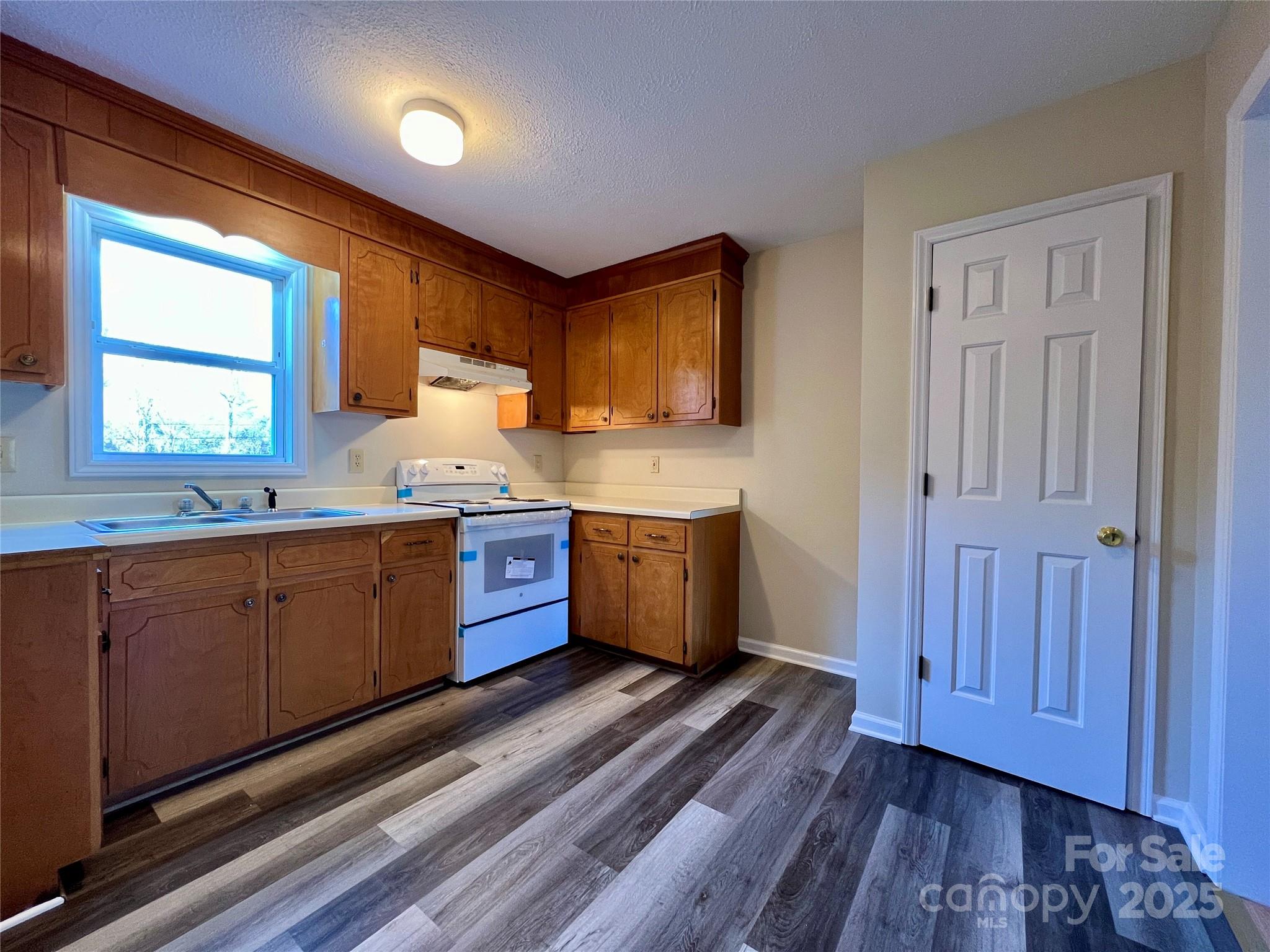 3 Wesley Branch Road Asheville, NC 28806 - Photo 6 of 19 a large kitchen with a large window a sink stainless steel appliances and cabinets