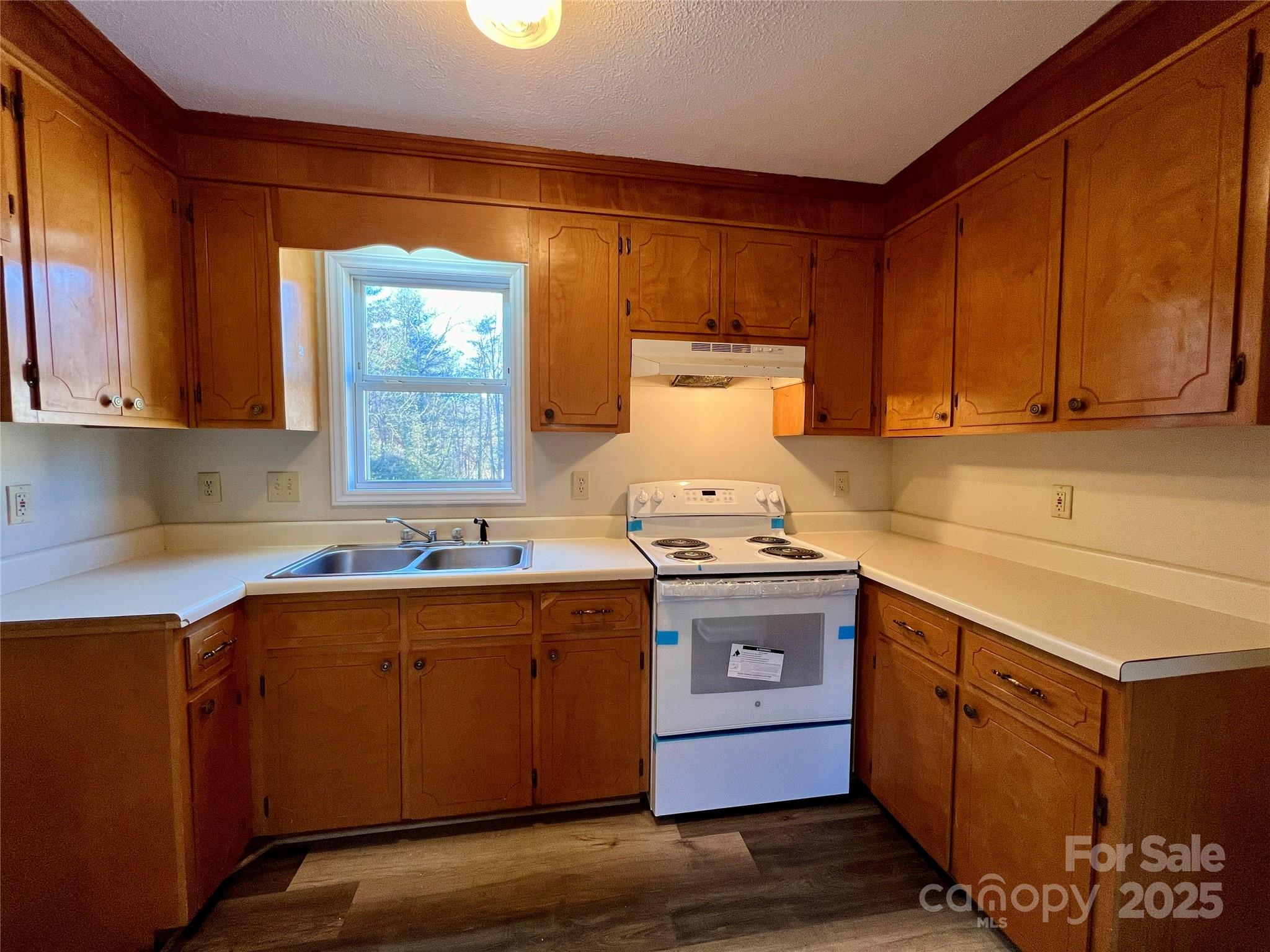 3 Wesley Branch Road Asheville, NC 28806 - Photo 7 of 19 a kitchen with stainless steel appliances granite countertop a sink stove and cabinets