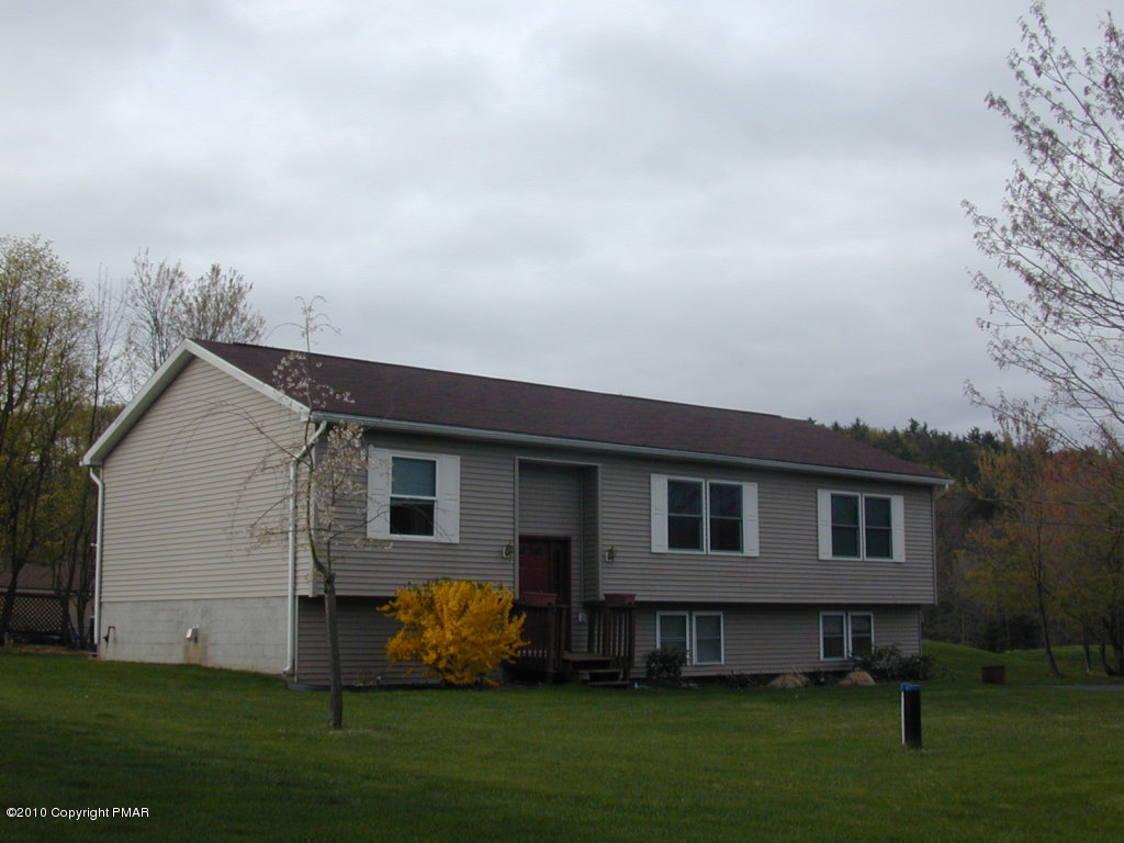 545 Berties Road Stroudsburg, PA 18360 - Photo 1 of 4 a front view of a house with a garden and yard