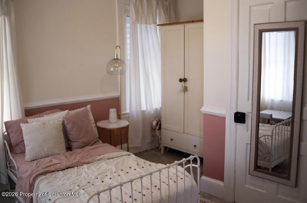 725 Main Street Delta, PA 17314 - Photo 21 of 30 a bedroom with a bed and a chandelier