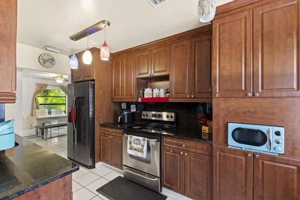 a kitchen with stainless steel appliances a stove a microwave and a refrigerator
