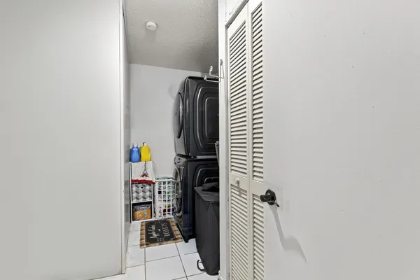 a view of a patio with table and chairs under an umbrella