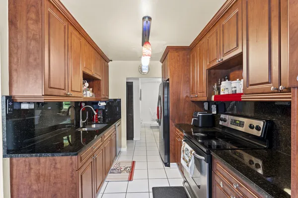 a kitchen with stainless steel appliances granite countertop a stove and a refrigerator
