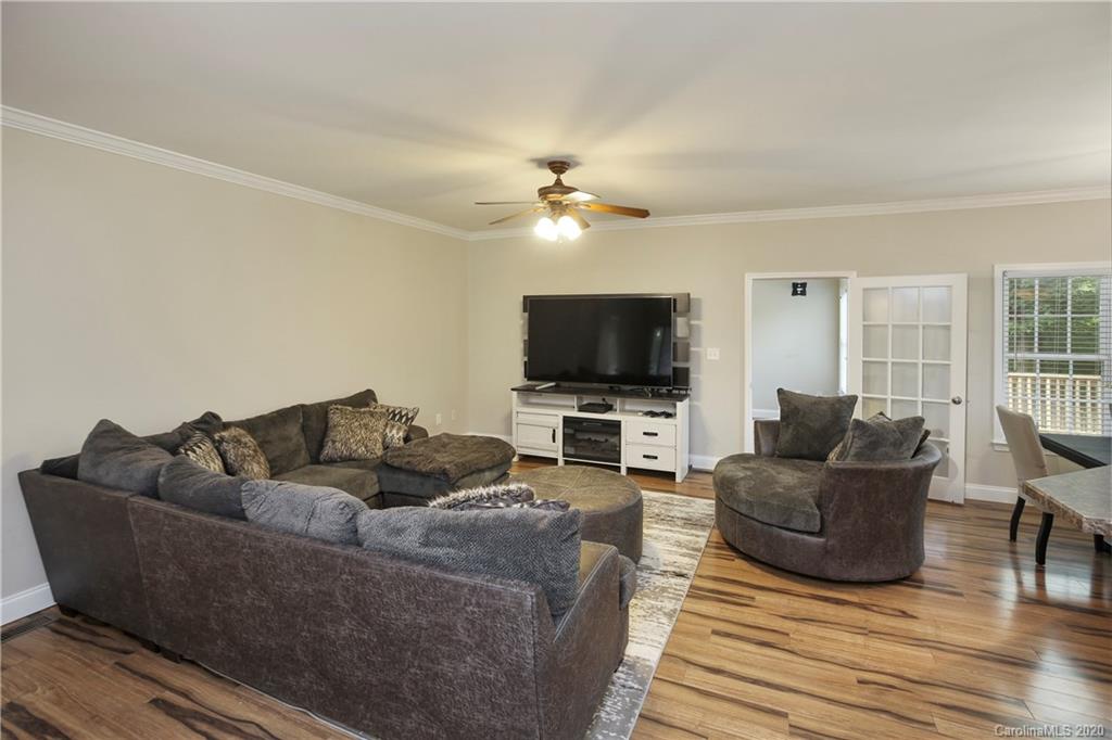 8737 Swift Road Oakboro, NC 28129 - Photo 2 of 19 a living room with furniture and a flat screen tv