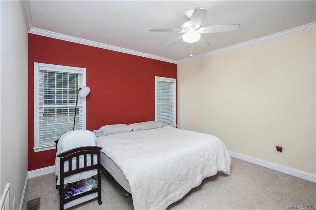 8737 Swift Road Oakboro, NC 28129 - Photo 14 of 19 a bedroom with a bed desk and a window