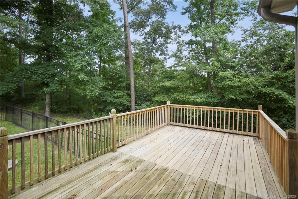 8737 Swift Road Oakboro, NC 28129 - Photo 17 of 19 a balcony with wooden floor and trees