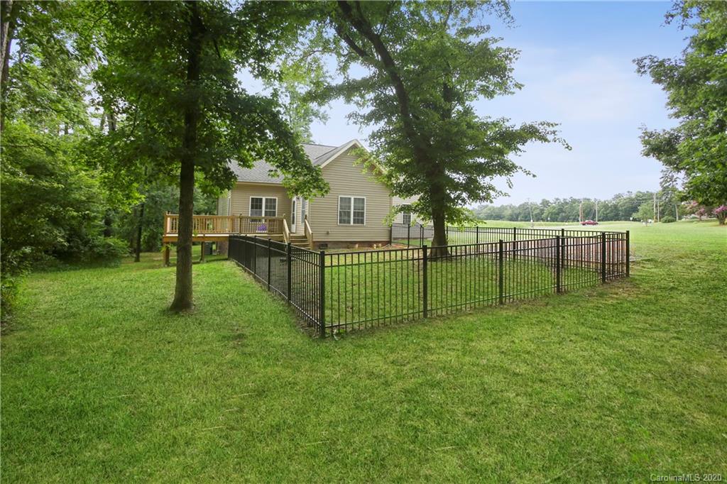 8737 Swift Road Oakboro, NC 28129 - Photo 19 of 19 a view of a house with a backyard and a tree
