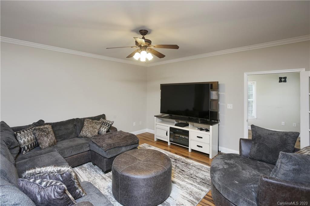8737 Swift Road Oakboro, NC 28129 - Photo 3 of 19 a living room with furniture and a flat screen tv
