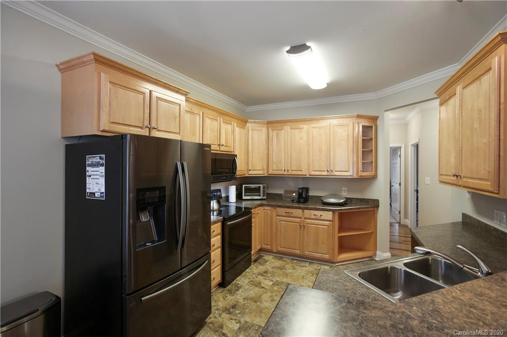 8737 Swift Road Oakboro, NC 28129 - Photo 6 of 19 a kitchen with stainless steel appliances granite countertop a refrigerator stove and sink