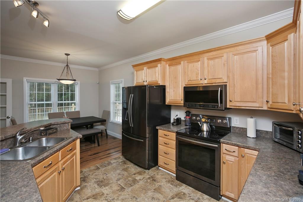8737 Swift Road Oakboro, NC 28129 - Photo 7 of 19 a kitchen with stainless steel appliances granite countertop a refrigerator stove and sink