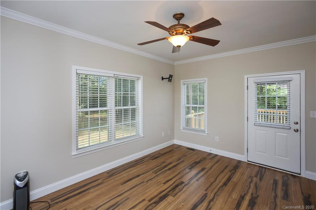 8737 Swift Road Oakboro, NC 28129 - Photo 9 of 19 a view of an empty room with wooden floor and a window