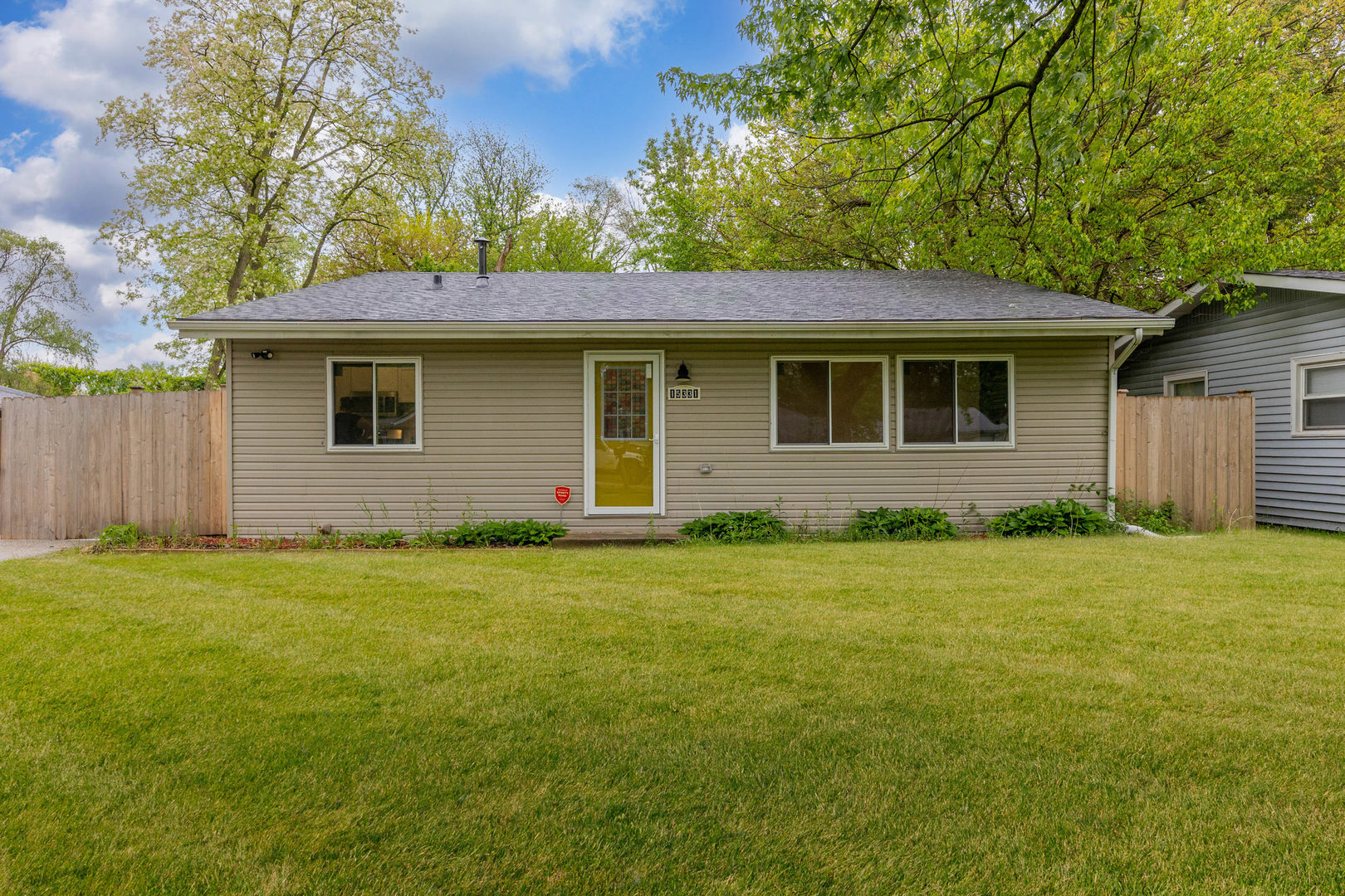 15331 Cherry Lane Markham, IL 60428 - Photo 1 of 23 a backyard of a house with plants and wooden fence