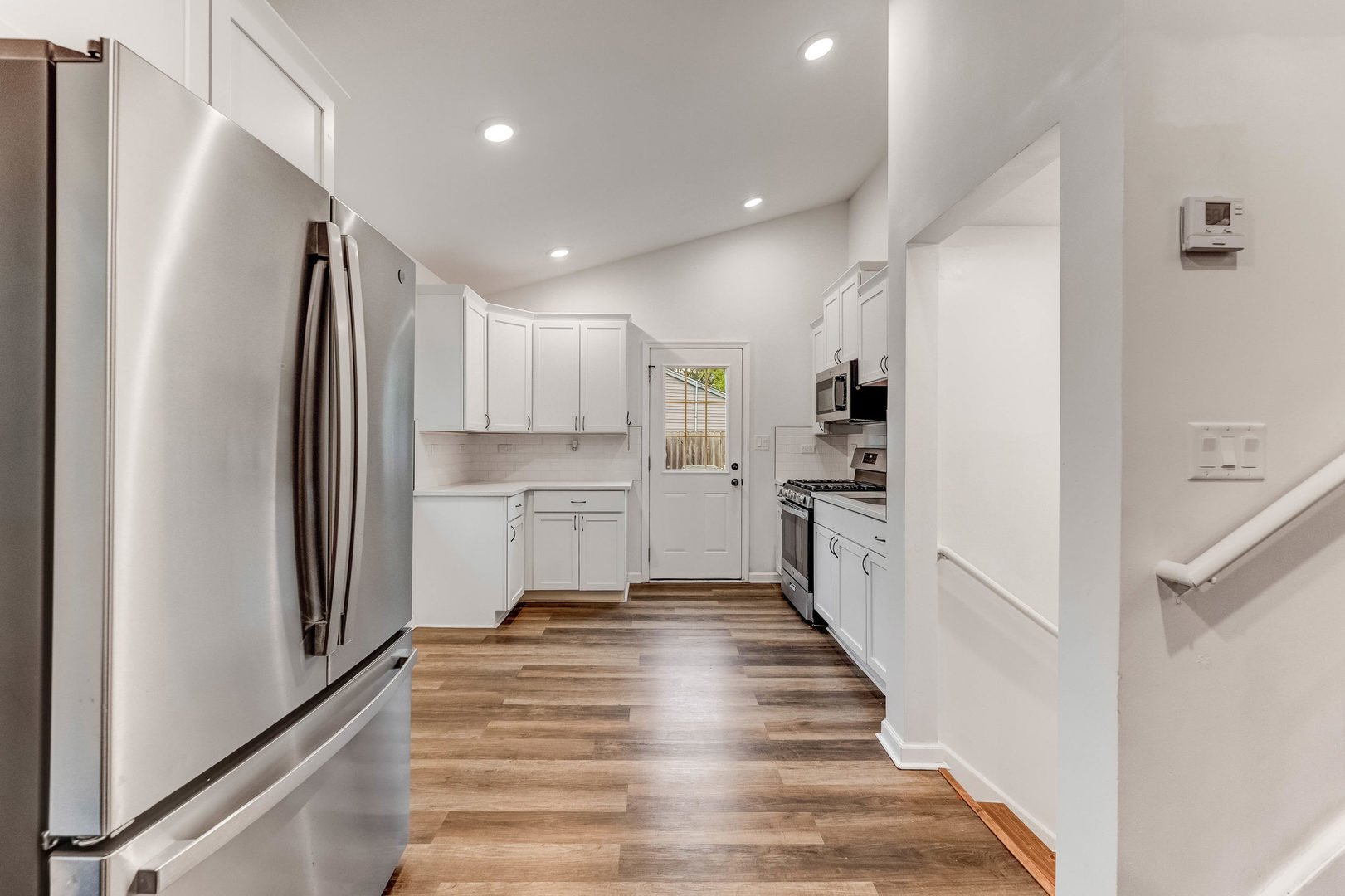 15331 Cherry Lane Markham, IL 60428 - Photo 5 of 23 a kitchen with white cabinets and stainless steel appliances