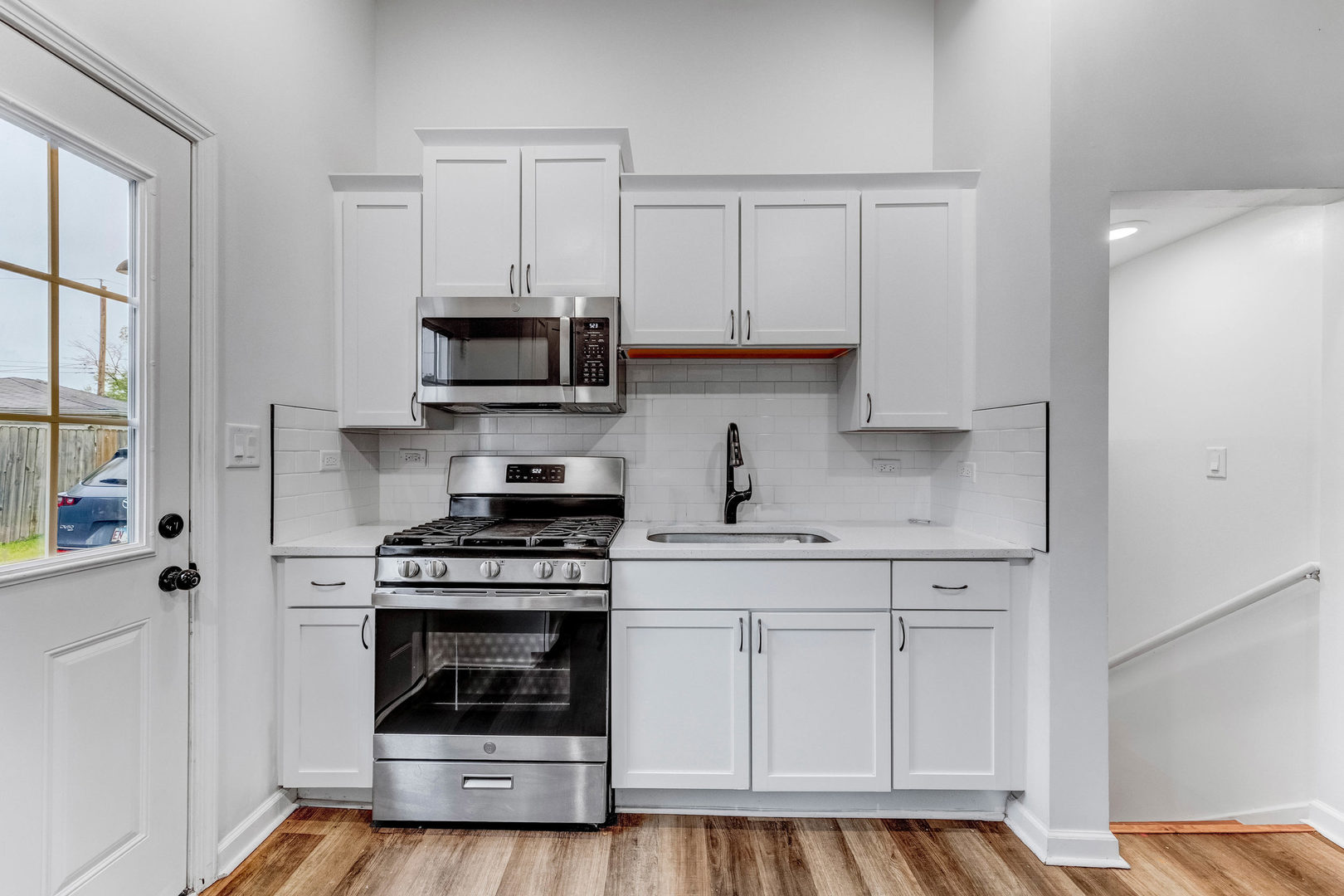 15331 Cherry Lane Markham, IL 60428 - Photo 6 of 23 a kitchen with white cabinets and appliances