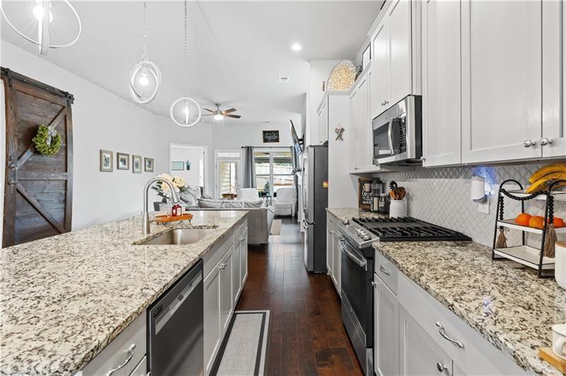 141 Fieldbrook Crossing Canton, GA 30115 - Photo 17 of 45 a kitchen with stainless steel appliances granite countertop a sink stove and refrigerator