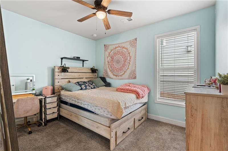 141 Fieldbrook Crossing Canton, GA 30115 - Photo 27 of 45 a bedroom with a bed and a chandelier