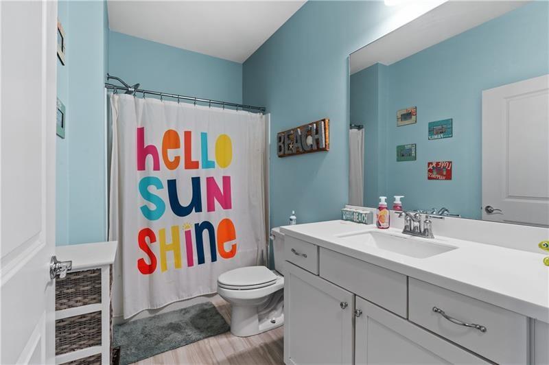 141 Fieldbrook Crossing Canton, GA 30115 - Photo 28 of 45 a bathroom with a sink a toilet and a curtain