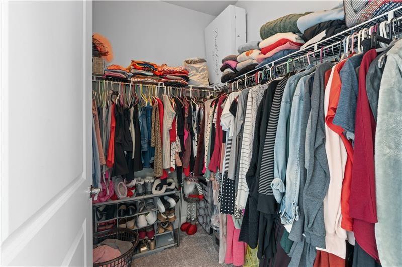141 Fieldbrook Crossing Canton, GA 30115 - Photo 32 of 45 a view of walk in closet with clothes