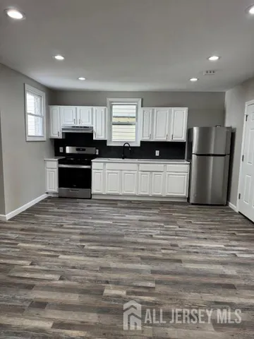 a kitchen with a refrigerator and a stove