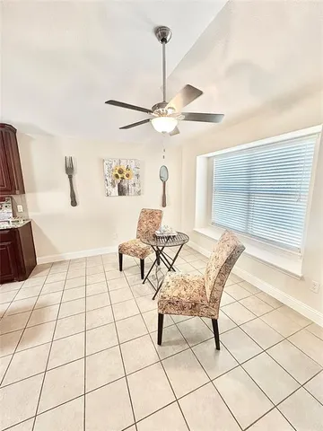 a living room with a baby crib furniture and a chandelier