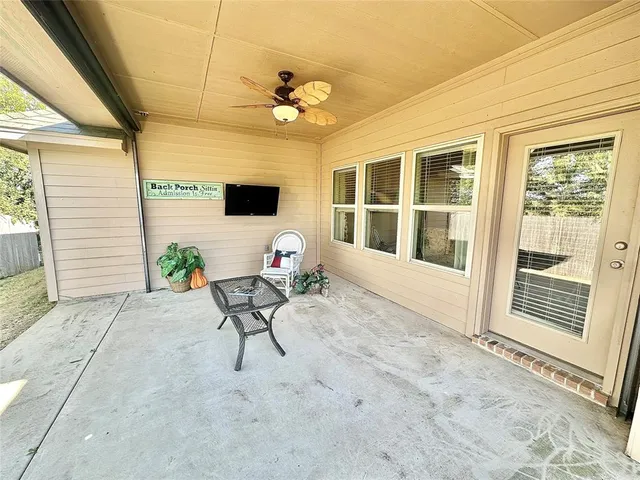 a view of a porch with a table and chairs