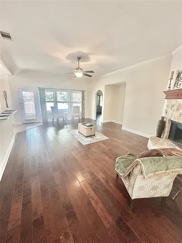 a living room with a bed furniture and a large window