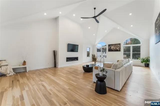 a living room with furniture wooden floor and a fireplace