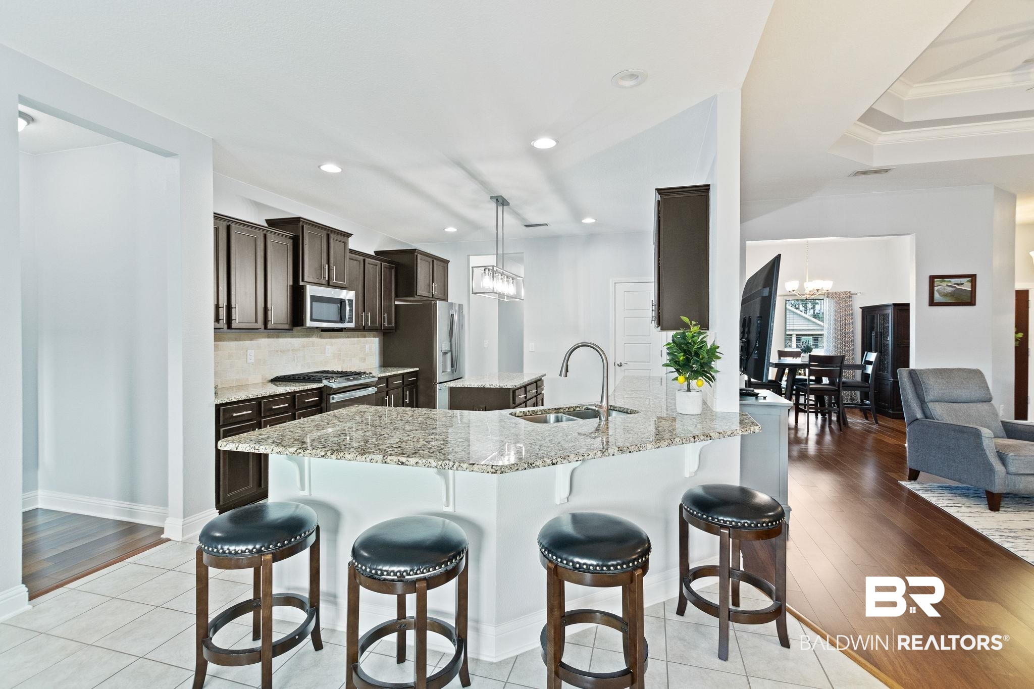 31541 Hoot Owl Road Daphne, AL 36527 - Photo 13 of 51 Kitchen featuring stainless steel appliances, pendant lighting, sink, light stone counters, and light hardwood / wood-style floors
