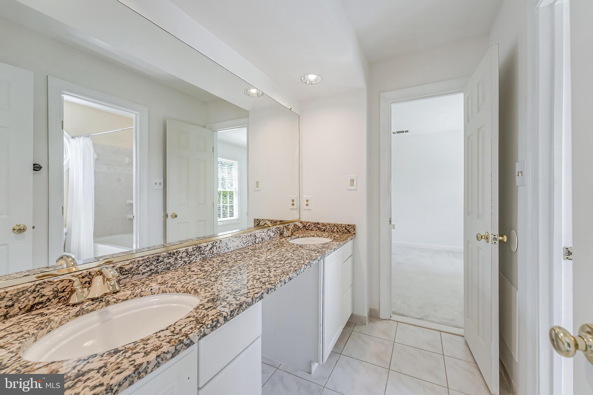 5501 Ashleigh Road Fairfax, VA 22030 - Photo 51 of 77 a bathroom with a granite countertop sink and a mirror