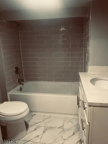 a bathroom with a sink a toilet and bathtub