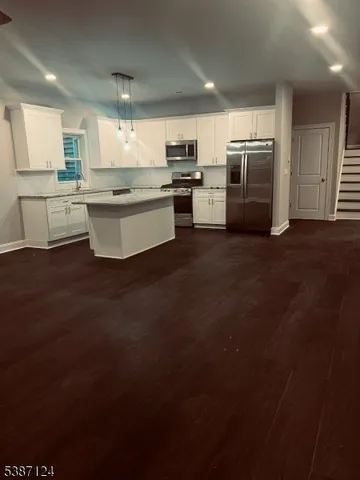 a large kitchen with cabinets and stainless steel appliances