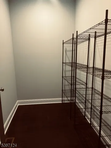 a view of room with wooden floor