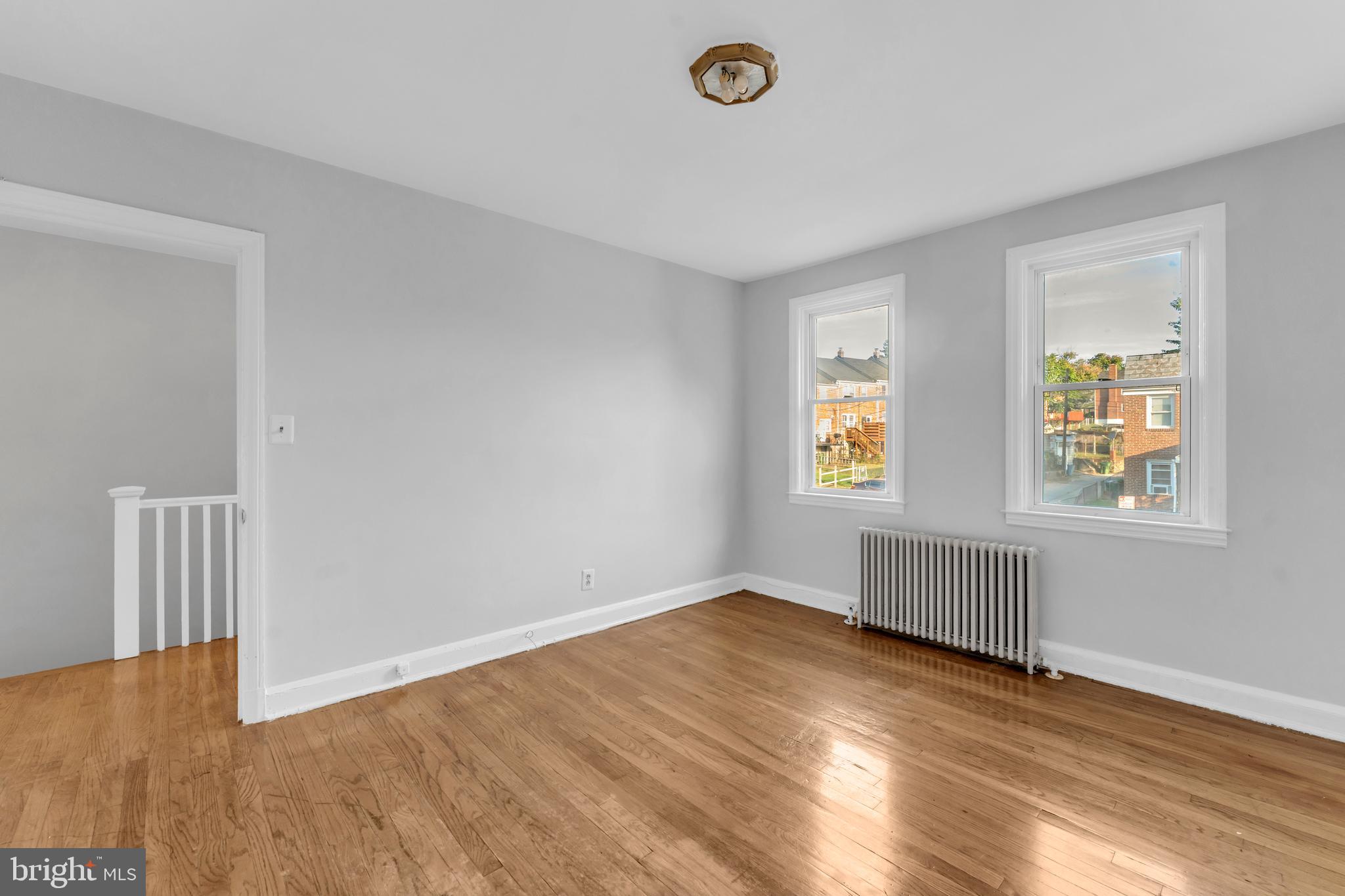 3937 Flowerton Road Baltimore, MD 21229 - Photo 15 of 28 a view of an empty room with wooden floor and a window
