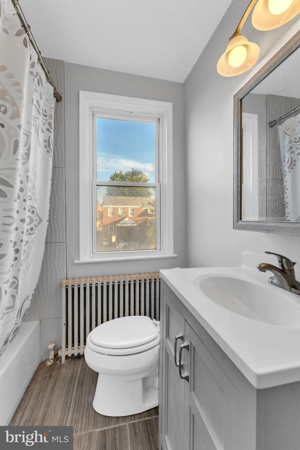 3937 Flowerton Road Baltimore, MD 21229 - Photo 17 of 28 a bathroom with a sink a toilet and a mirror