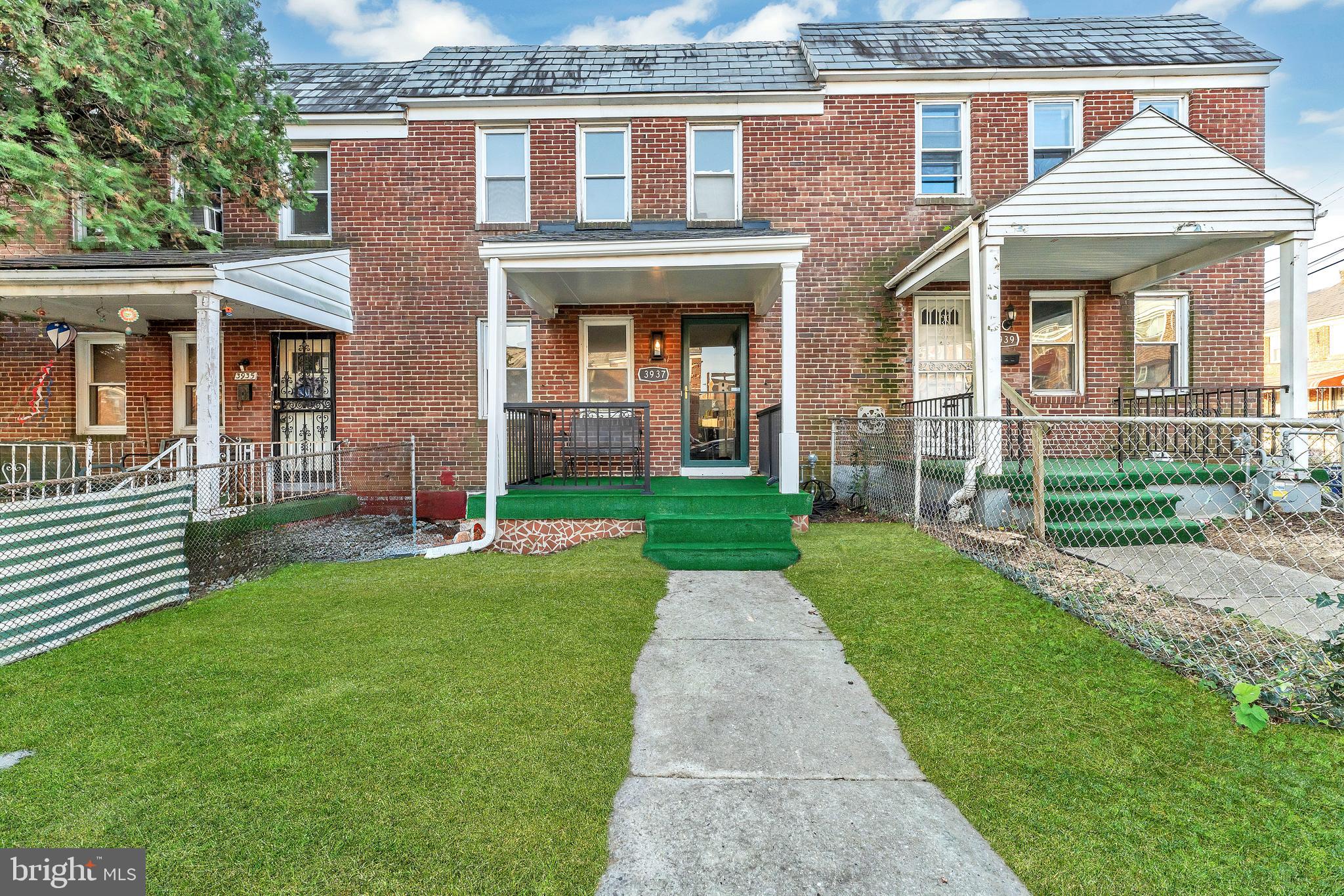 3937 Flowerton Road Baltimore, MD 21229 - Photo 2 of 28 front view of a brick house with a yard