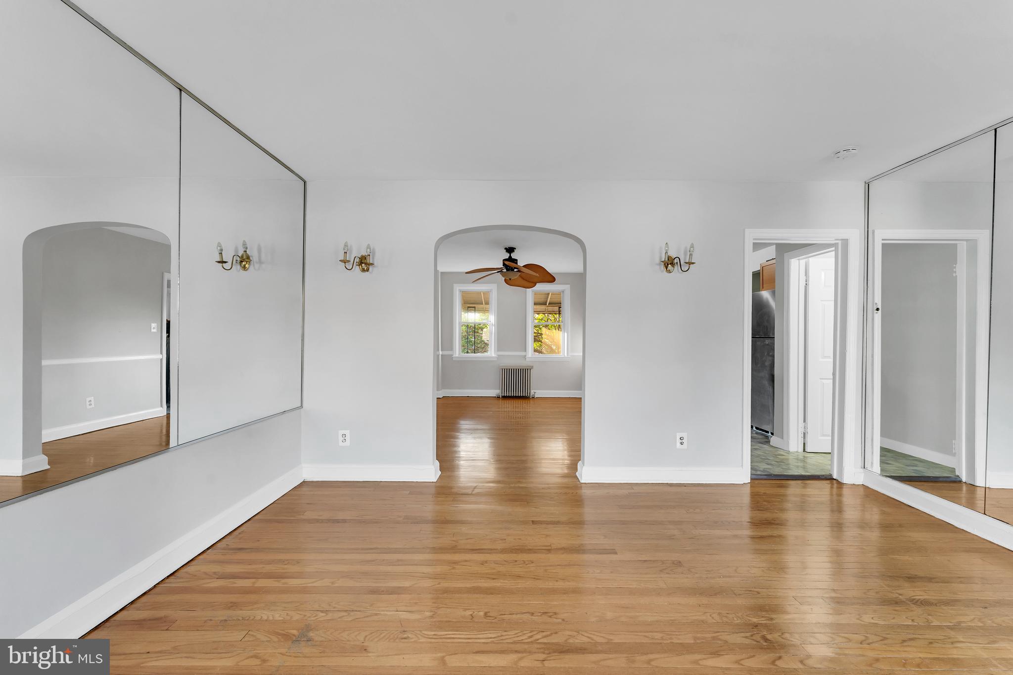 3937 Flowerton Road Baltimore, MD 21229 - Photo 5 of 28 a view of an empty room with wooden floor and a window