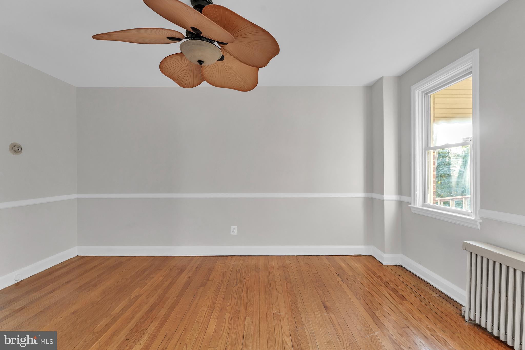 3937 Flowerton Road Baltimore, MD 21229 - Photo 7 of 28 wooden floor in an empty room with a window