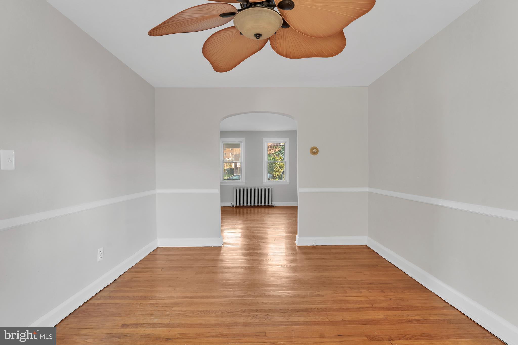3937 Flowerton Road Baltimore, MD 21229 - Photo 8 of 28 a view of an empty room with wooden floor and a window