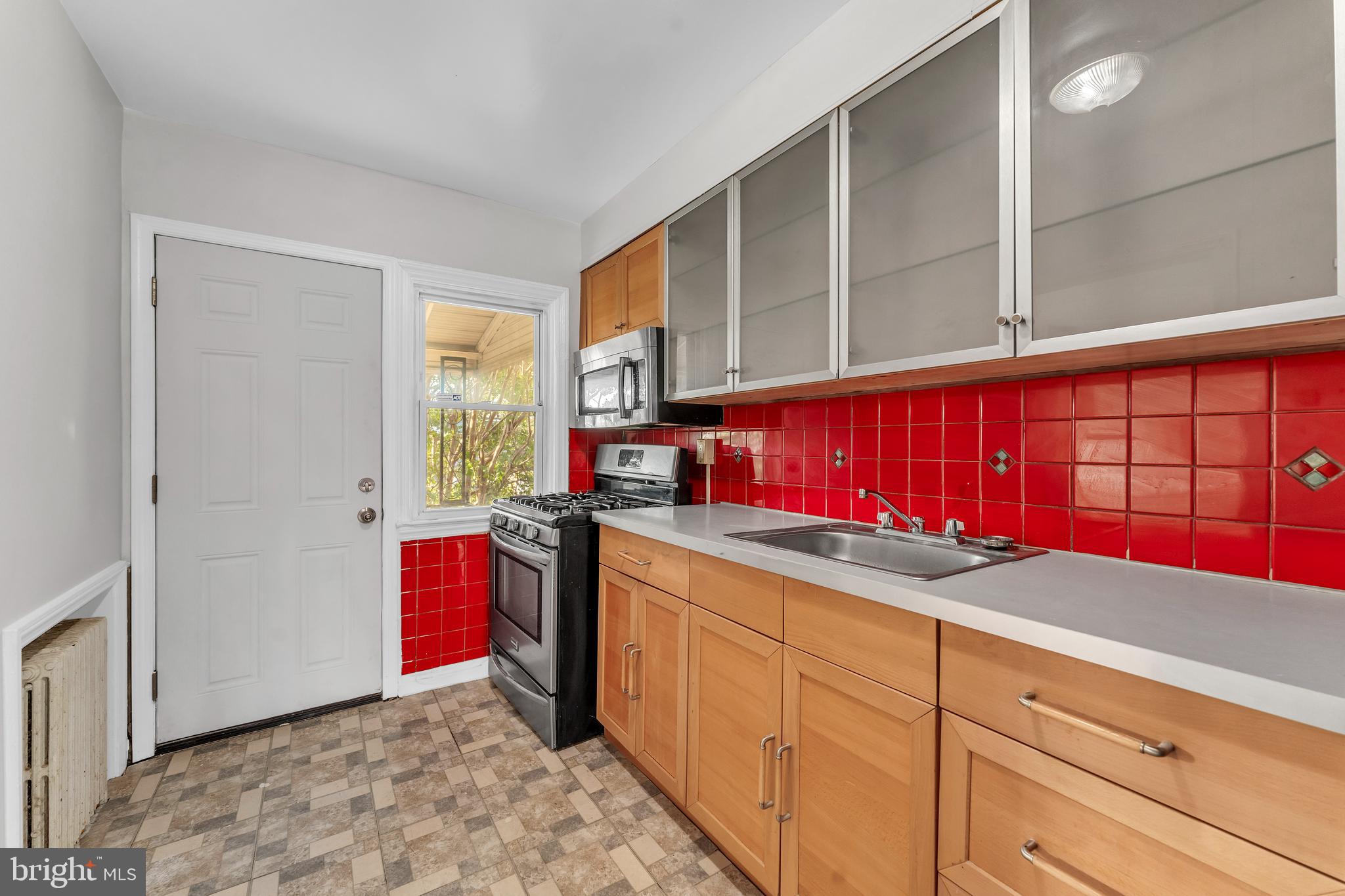 3937 Flowerton Road Baltimore, MD 21229 - Photo 9 of 28 a kitchen with stainless steel appliances granite countertop a sink stove and cabinets