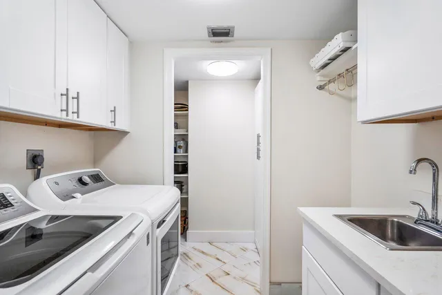 a kitchen with a sink and cabinets