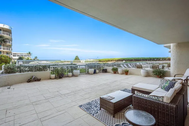 a view of a balcony with furniture and city view