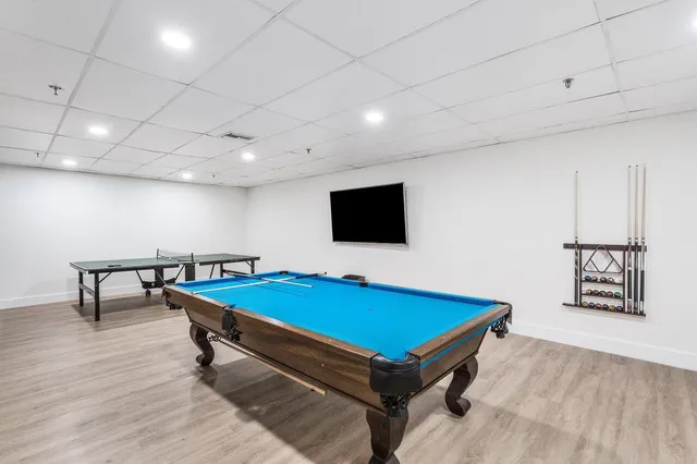 a room with pool table and a flat screen tv