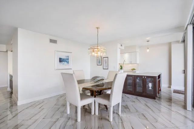 a view of a dining room with furniture wooden floor and chandelier