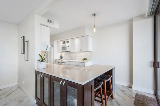 a kitchen with a stove a refrigerator and a sink