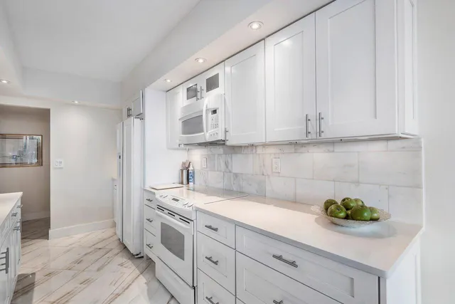 a kitchen with stainless steel appliances white cabinets and a sink