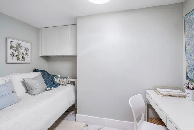 a bedroom with a bed and a table in it