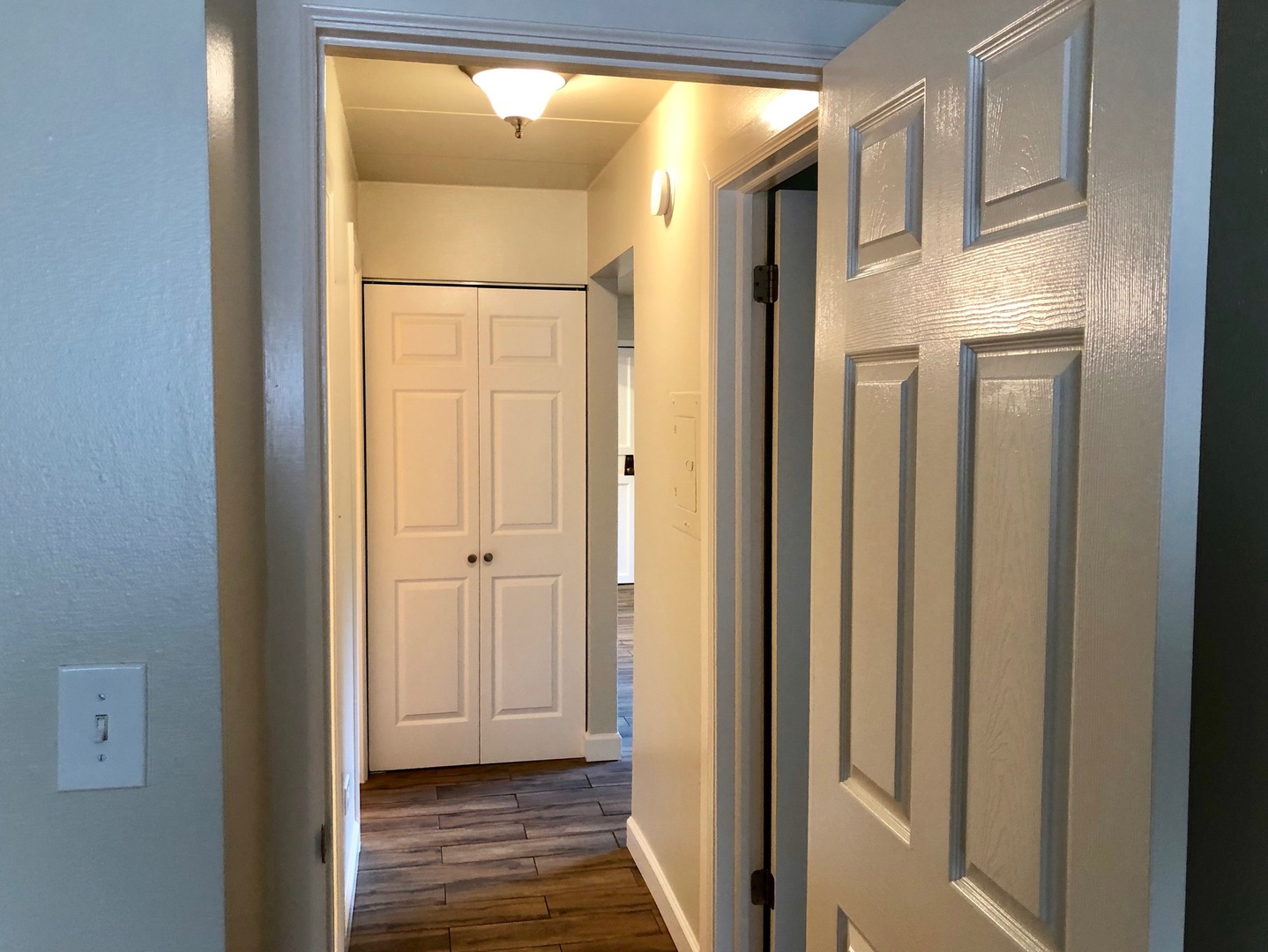 208 East Bailey Road, Unit A Naperville, IL 60565 - Photo 13 of 20 a view of a hallway with wooden floor and a bathroom